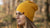 Woman weearing yellow beanie hat from merino wool