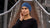 Woman wearing a blue headband outdoors on a wooden bridge