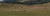 Sheep grazing in a field with mountains in the background