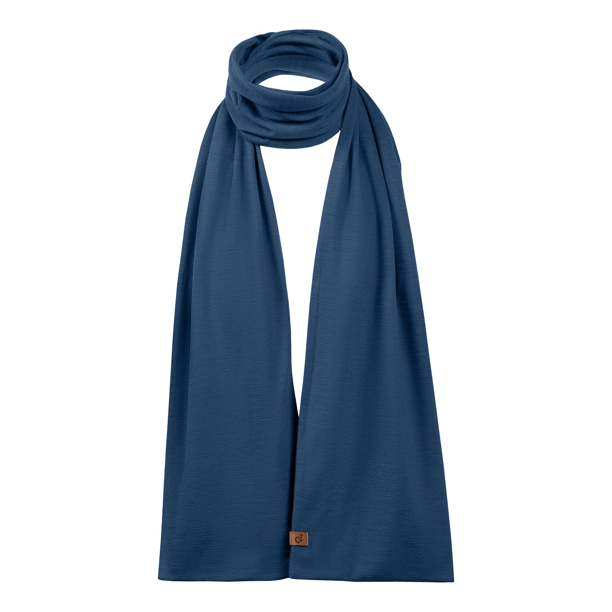 Man wearing a blue merino wool scarf on black merino long sleeve shirt standing in a forest