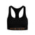Woman wearing a black Merino wool sports bra with racerback design, posing with one arm raised.