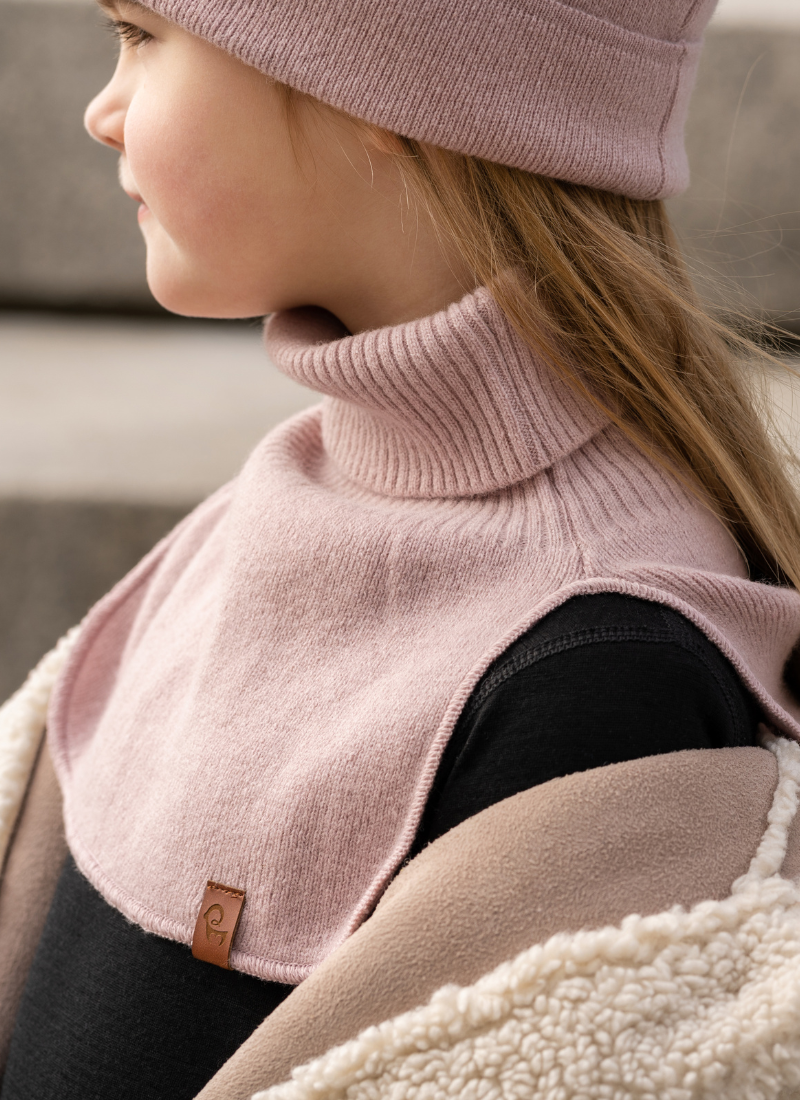 Girl standing outdoors and wearing dusty pink neck turtle dickie