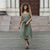 Woman wearing stone green linen skirt Sophia.